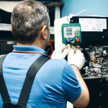 technician performing air conditioning maintenance technician performing air conditioning maintenance